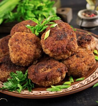 a plate of meatballs and greens