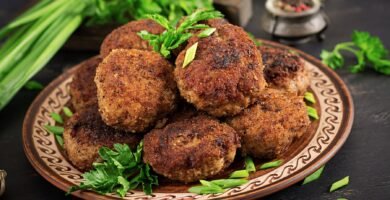 a plate of meatballs and greens