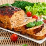 a plate of food with tomatoes and greens