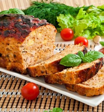 a plate of food with tomatoes and greens