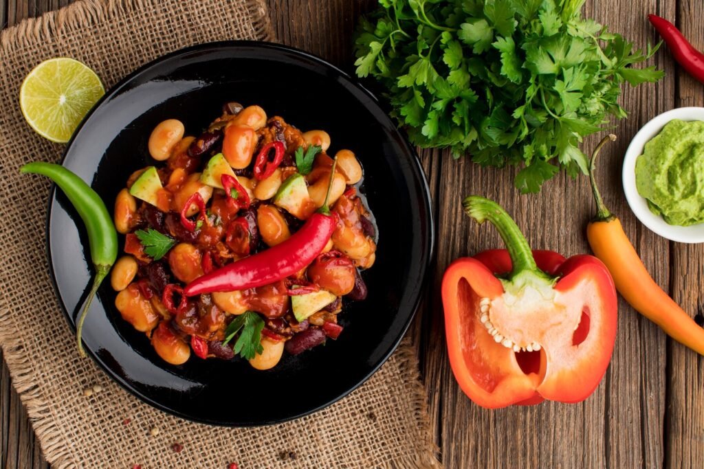 a plate of food next to a pepper and a pepper